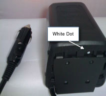 A small white dot on the base of the charger.